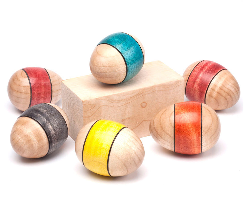 A group of turned eggs with different colored dyed bands.