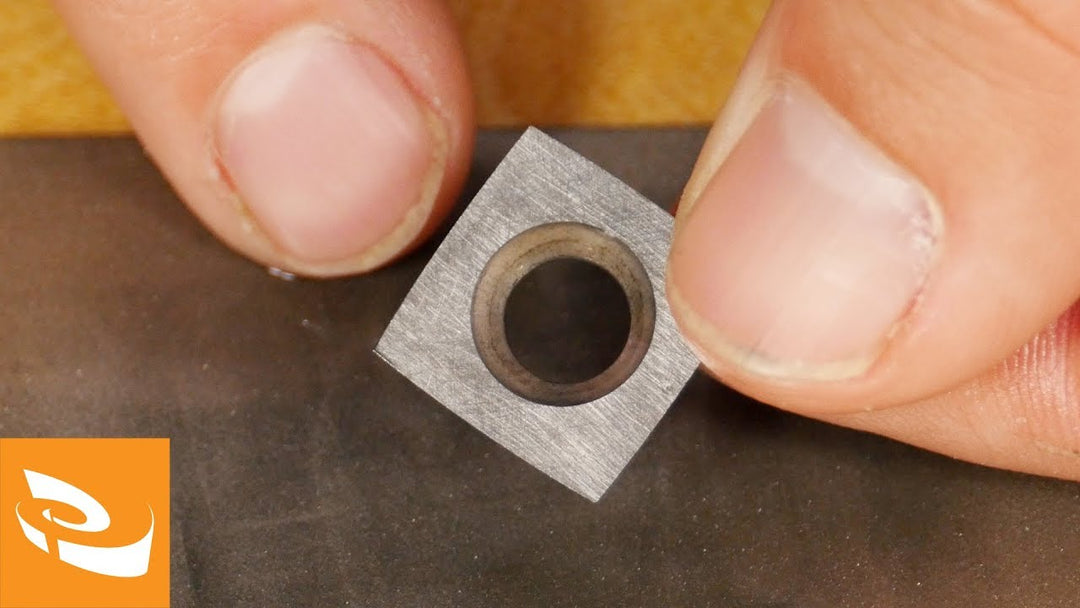 A closeup of a square carbide cutter.