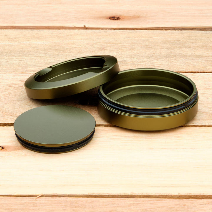 Green aluminum pouch case on a wooden surface