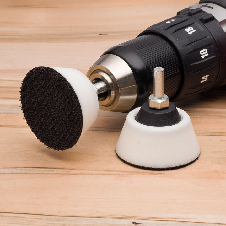 Drill with sanding disc holder on a wooden surface