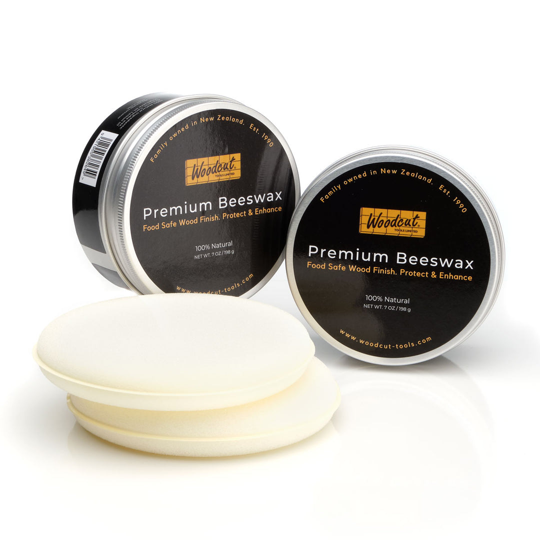 Two containers of Woodent Premium Beeswax on a white background